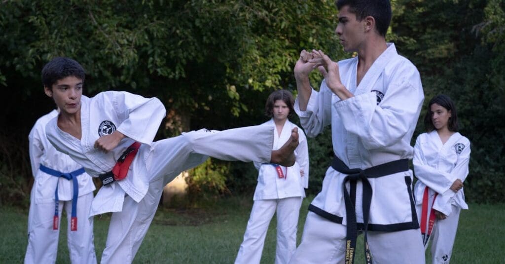 American Kenpo students practicing roundhouse kick techniques and sparring skills outdoors