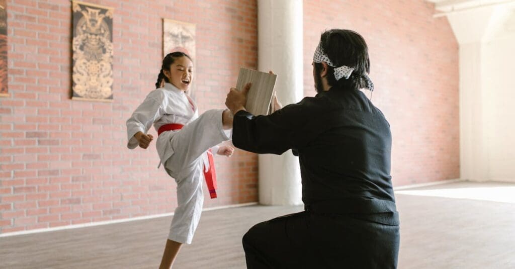 Student learning basic techniques and front kick combinations in kenpo karate training for beginners