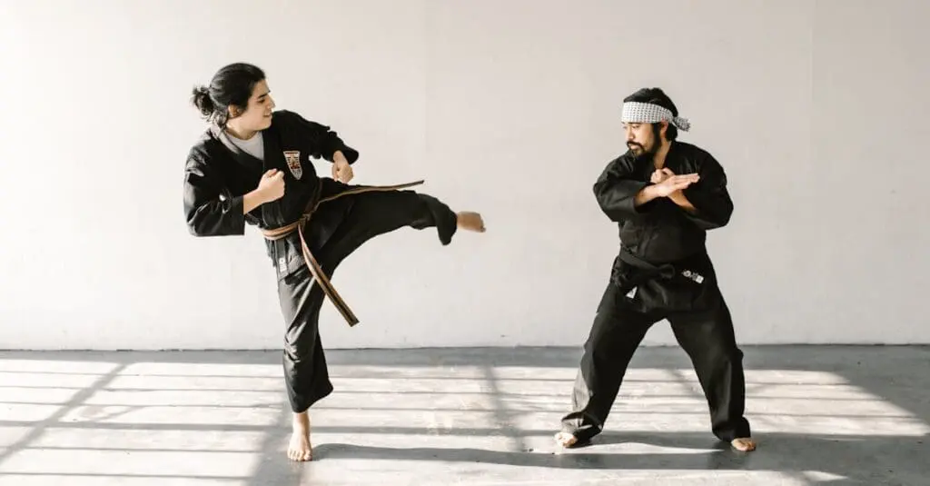 Beginner practicing kenpo karate side kick drills during martial arts training for physical fitness and balance